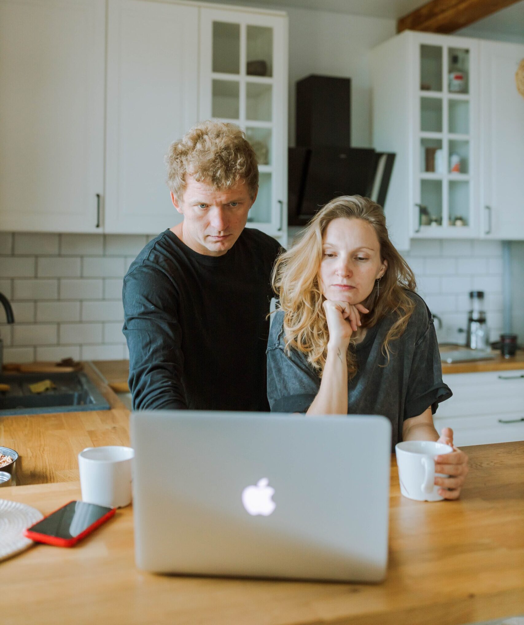 A couple reviewing their duplex investment strategy together on a laptop at home